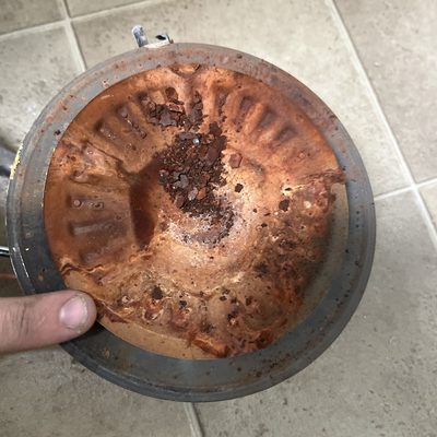 Rusted bottom of an old water heater tank